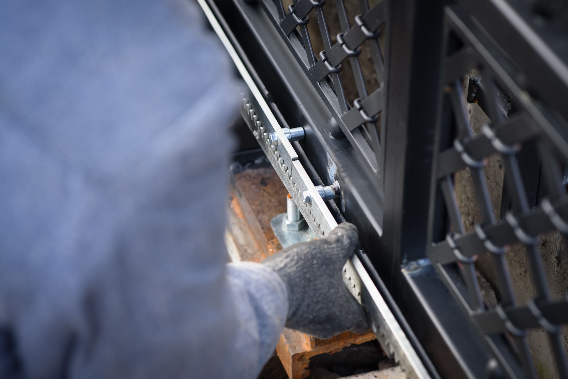 Specialist carries out work on installation and commissioning of sliding gates. Professional service of installation and maintenance of automatic cantilever sliding gate